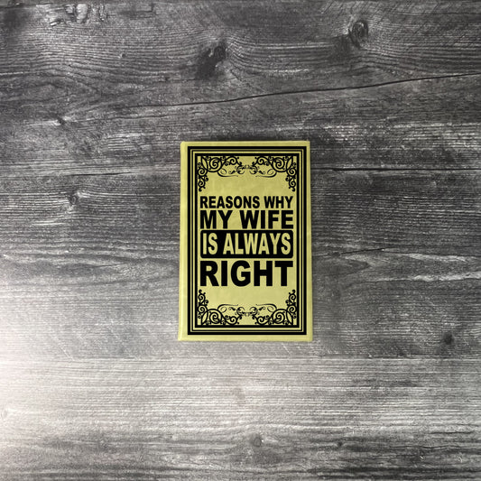 Olive colored leatherette journal on wooden background