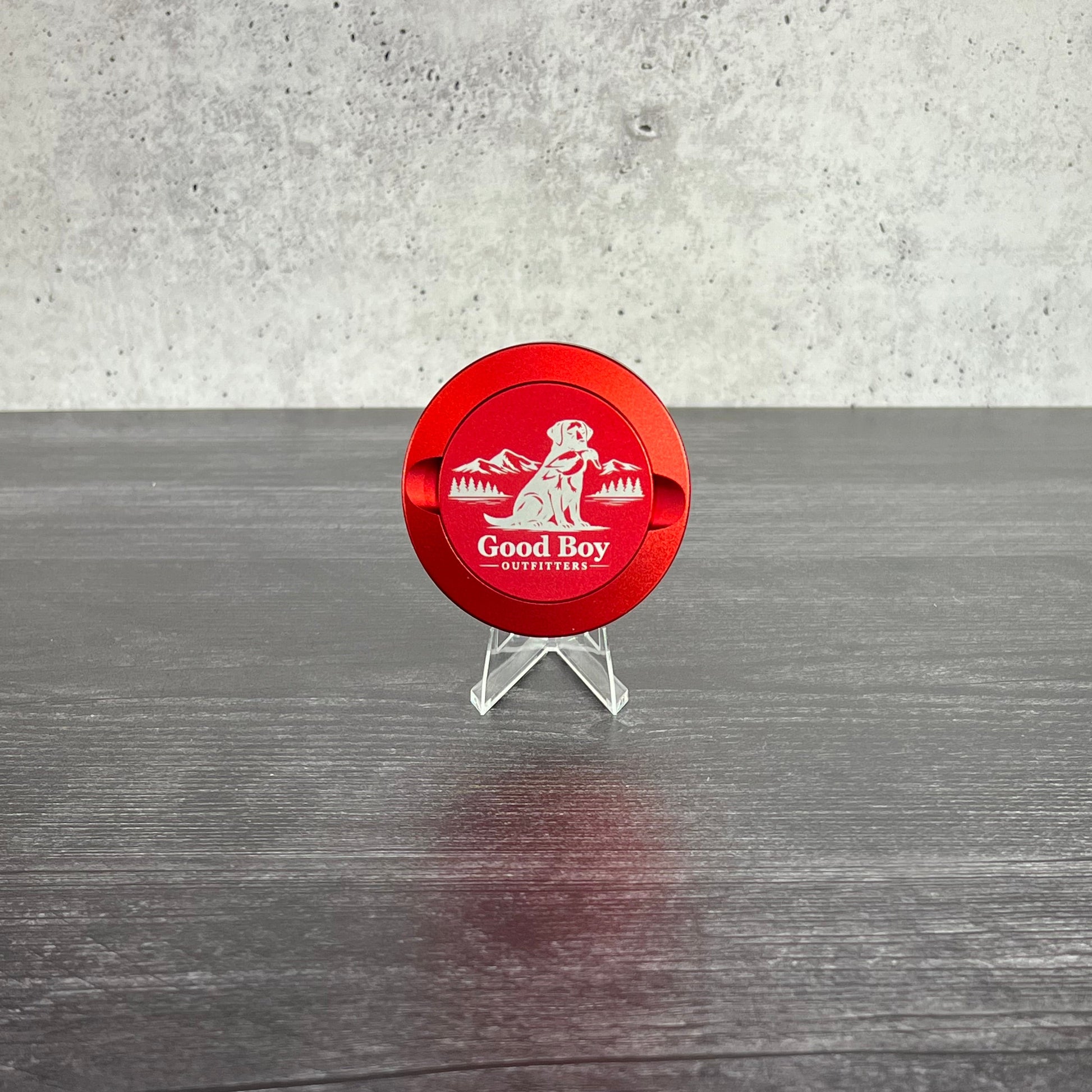 Red GBO Aluminum dip can with GBO  logo on a concrete and wooden surface