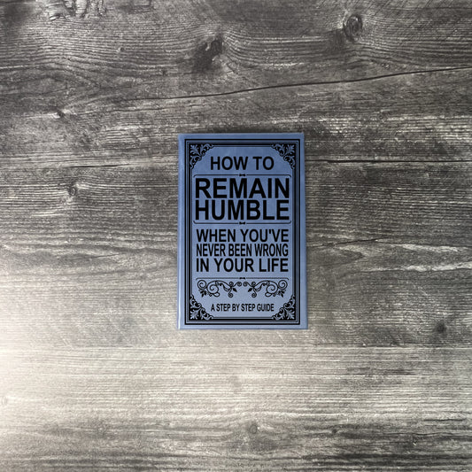 Book titled 'How to Remain Humble When You've Never Been Wrong in Your Life' on a wooden surface.