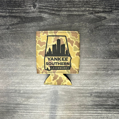 Camo-patterned can cooler with 'Yankee Southern' logo on a wooden surface