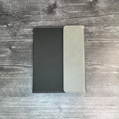Two leather-bound books on a wooden surface