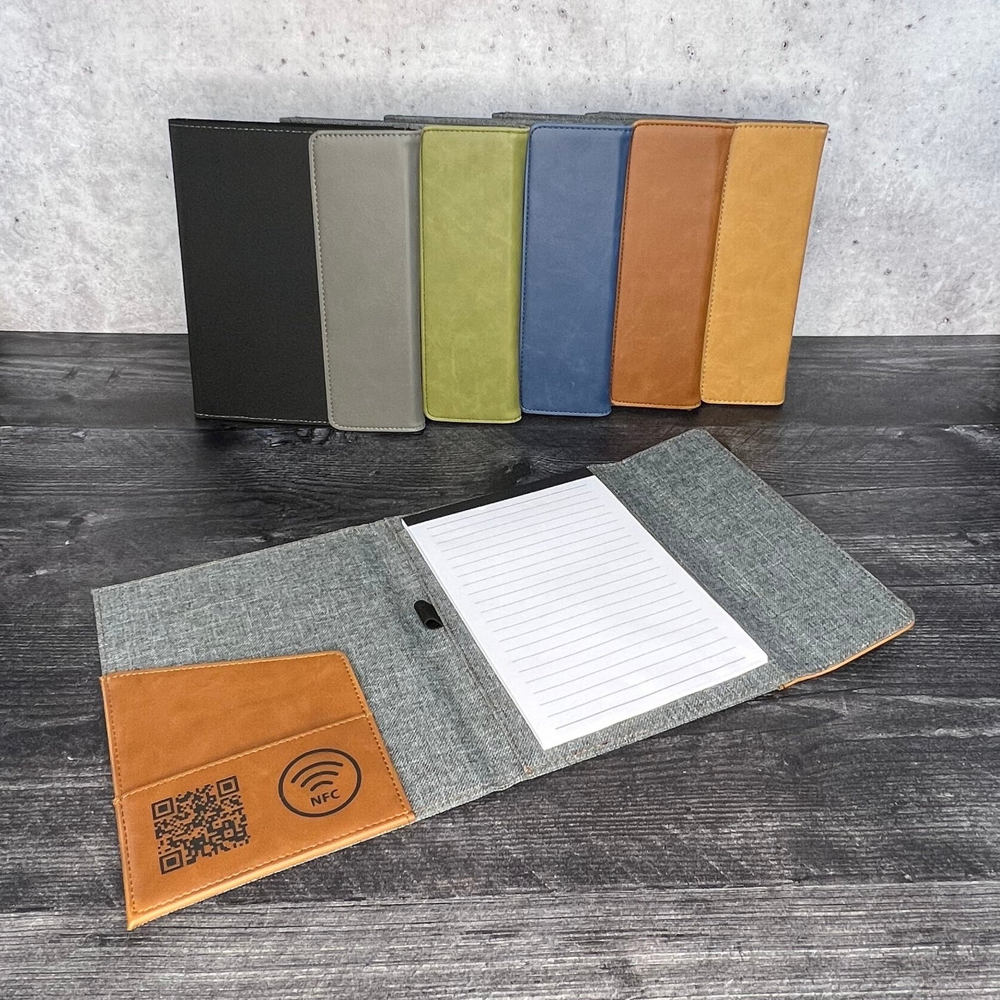 Color swatches and a sample book on a wooden surface with a gray wall in the background.