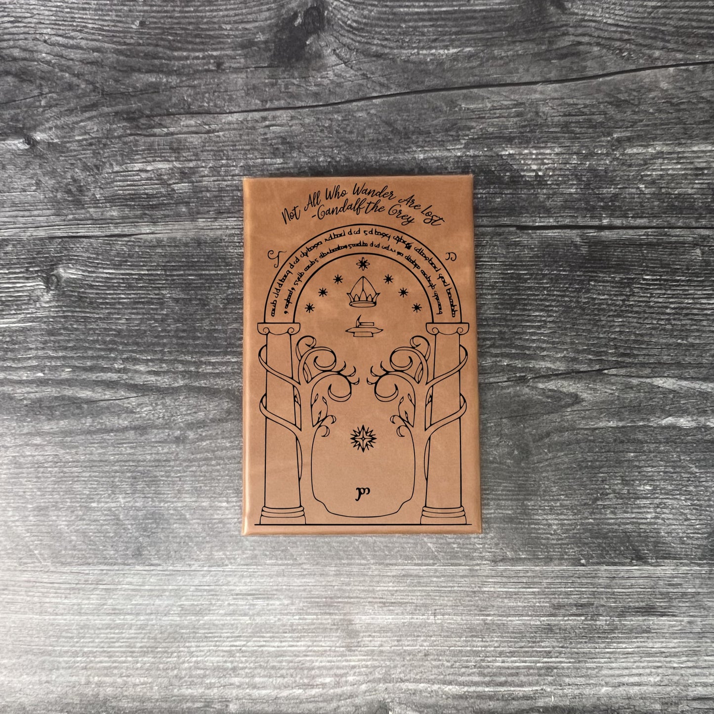 Walnut leatherette journal on a wooden floor with a concrete wall