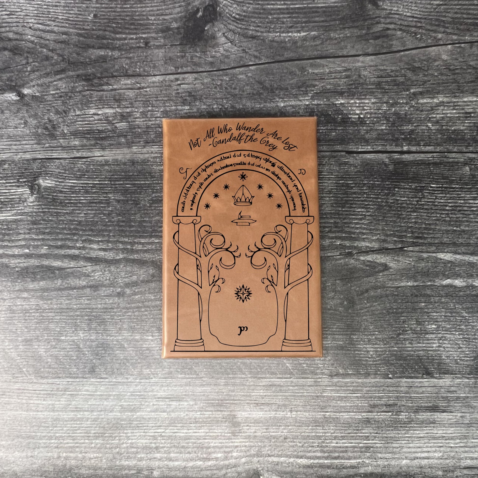 Walnut leatherette journal on a wooden floor with a concrete wall