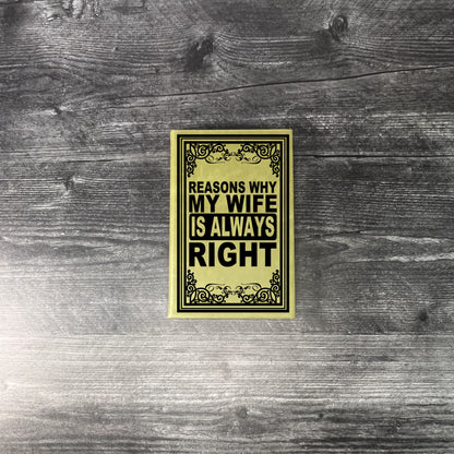 Book titled 'Reasons Why My Wife is Always Right' on a wooden surface